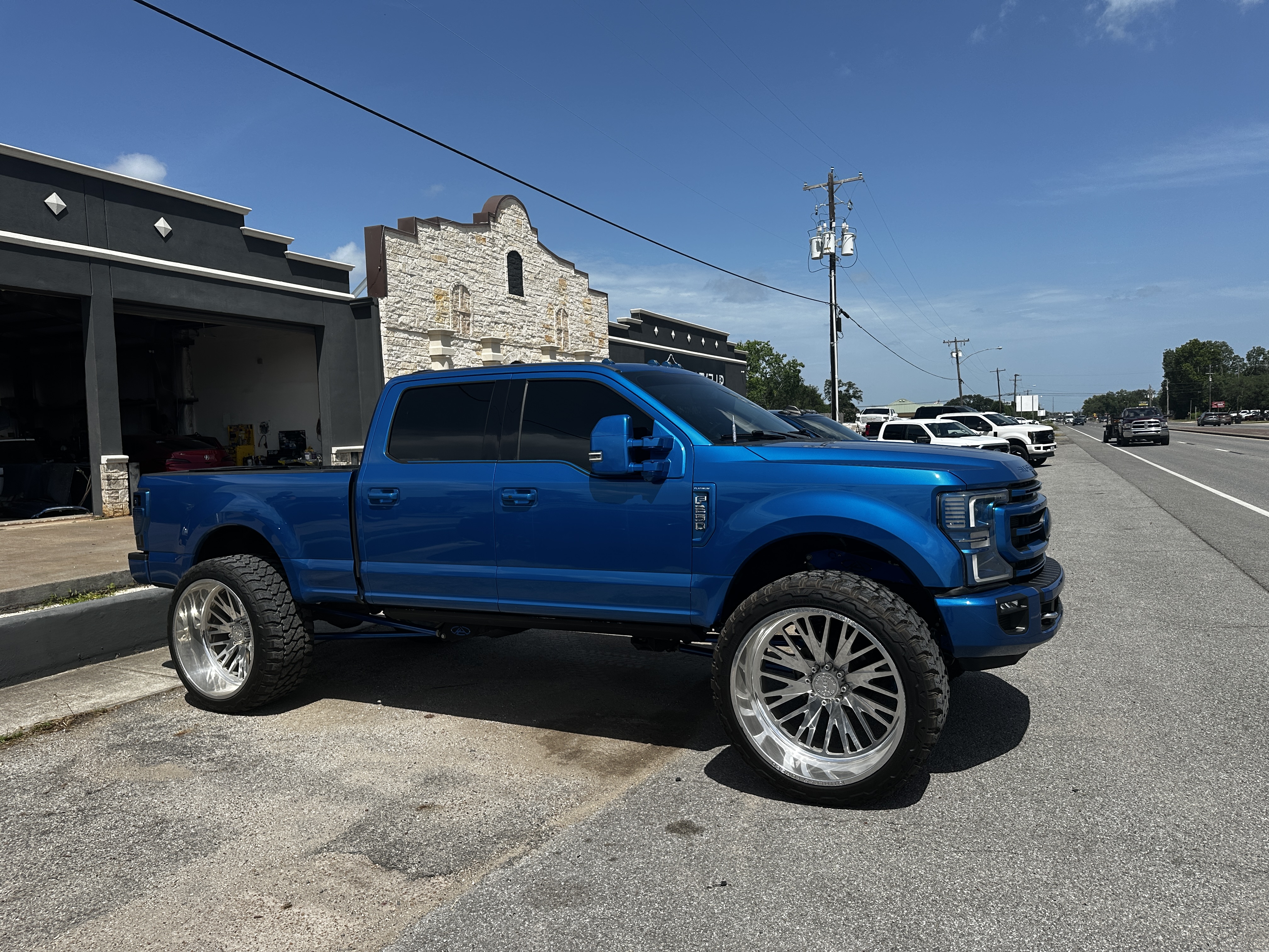 Candy blue Ford F-250 Platinum with polished forged wheels and lift kit, Level Up Customs, Alvin TX
