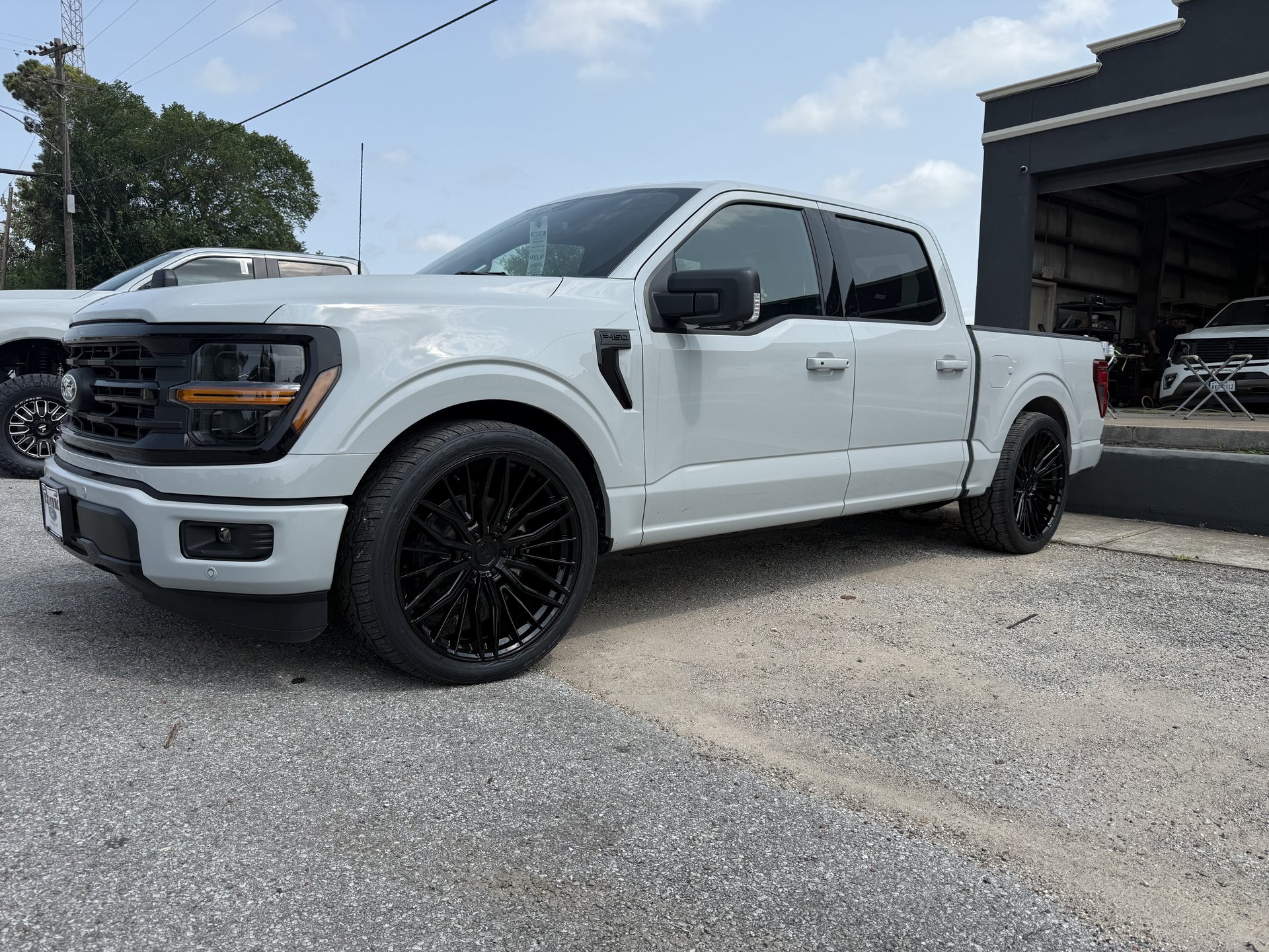 White Ford F-150 with custom wheel and tire package, Level Up Customs, Alvin TX