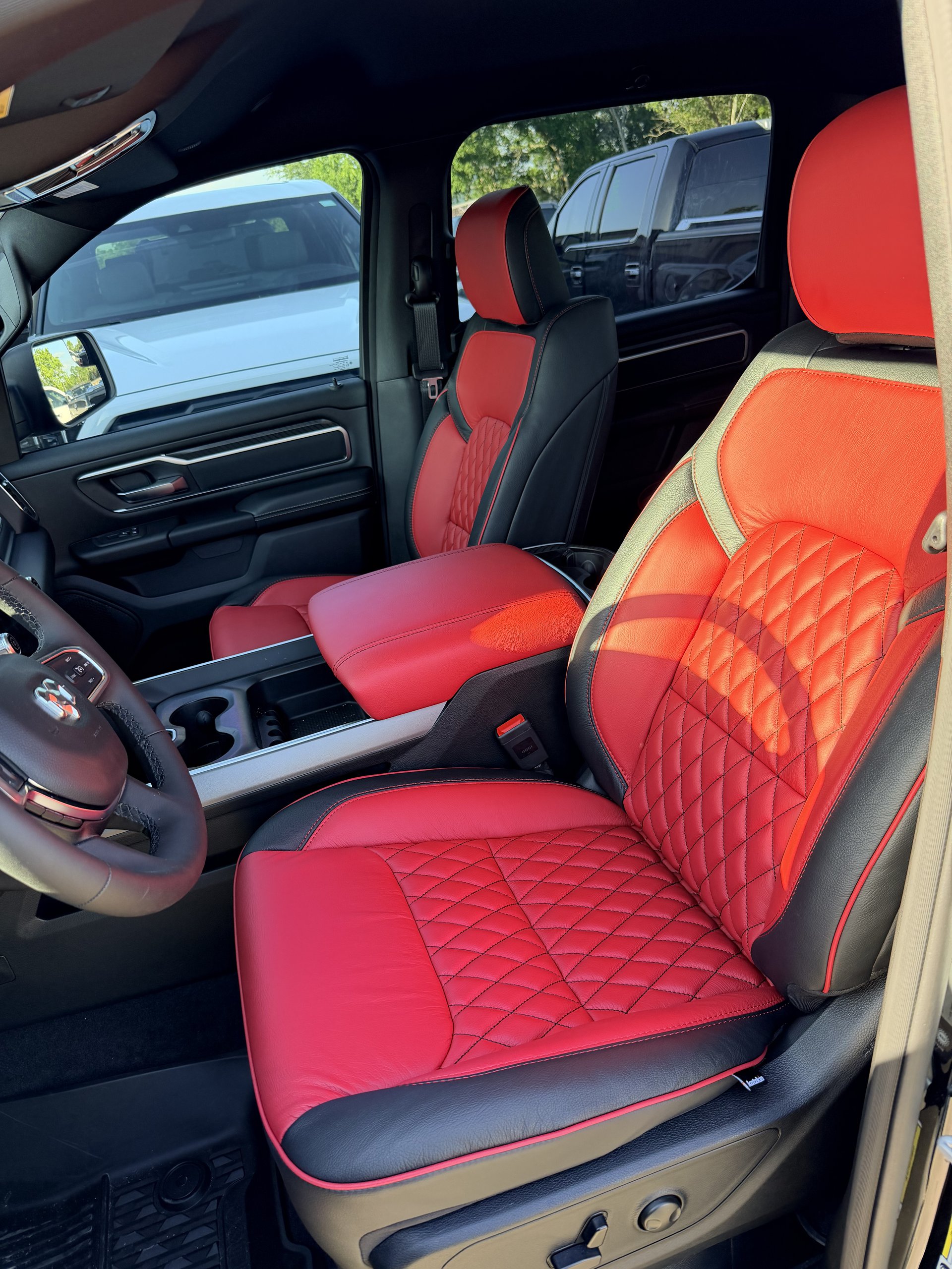 RAM truck with red and black diamond-stitch leather front seats, Level Up Customs, Alvin TX