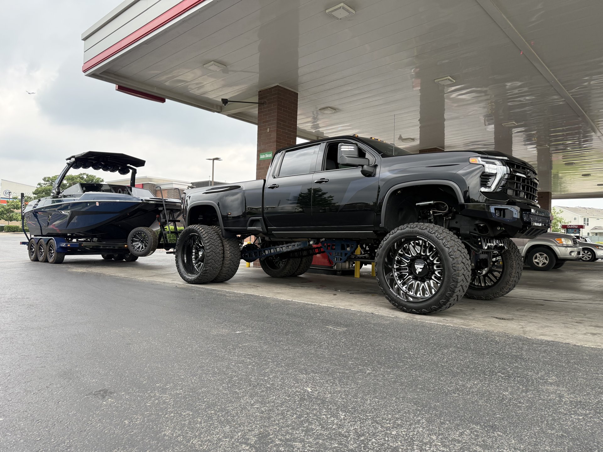 Lifted truck towing a boat — Level Up Customs build, Alvin TX